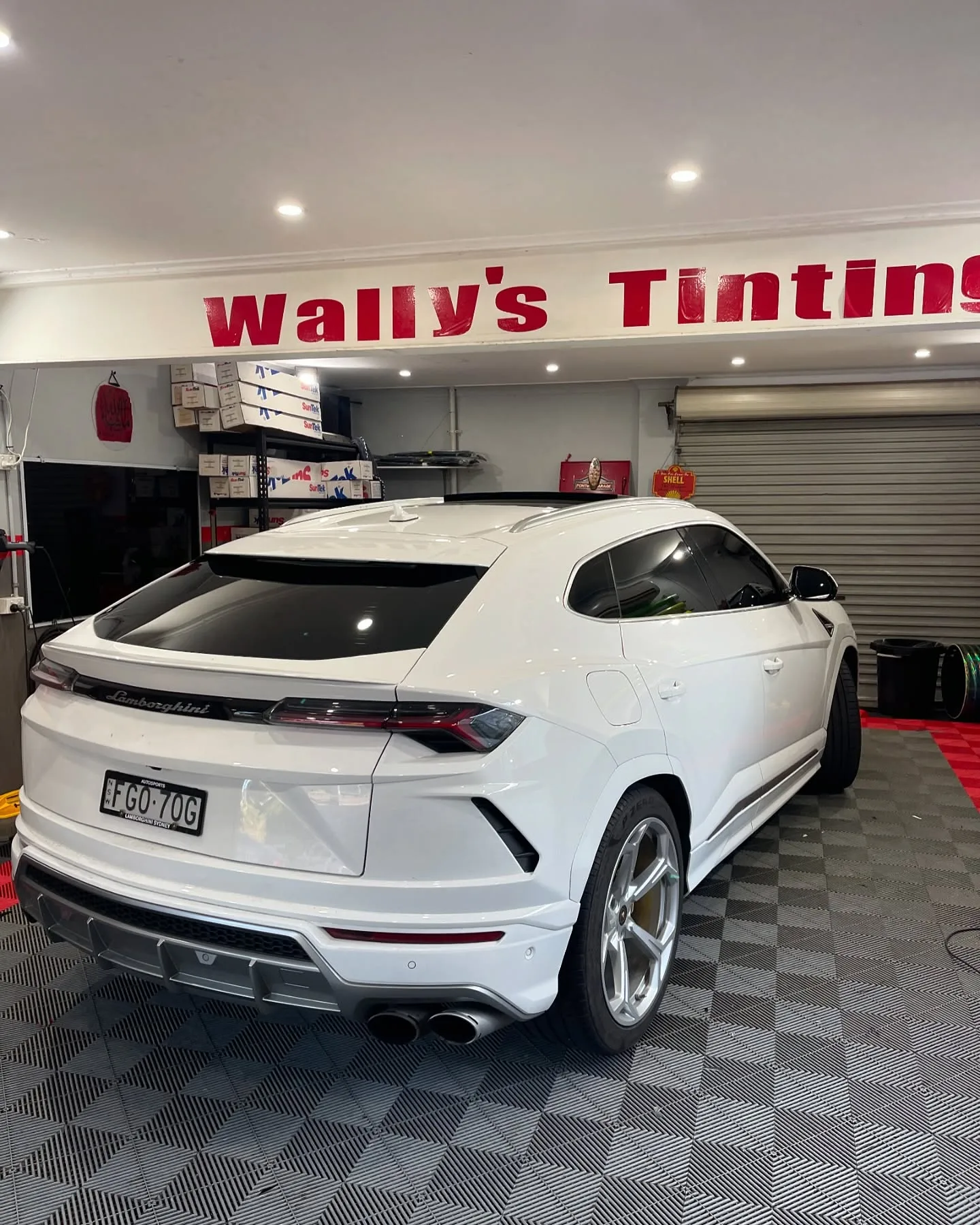 White Lamborghini Urus with tinted rear and side windows at Wally’s